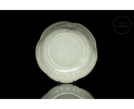 A modelled ceramic vessel in the form of a deep bowl with a circular base, curved profile and lobed rim, similar to the petal