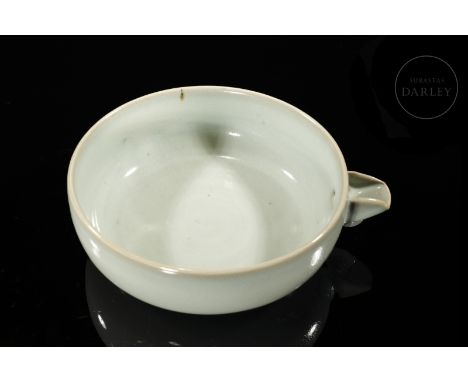 A ceramic bowl covered with a beautiful greyish-blue glaze, thinner at the rims, with a fine network of craquelure and small 