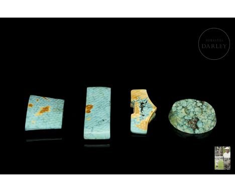 Four pieces of carved turquoise, deep blue, with ochre and greenish flecks. This set of pieces was traditionally attached to 