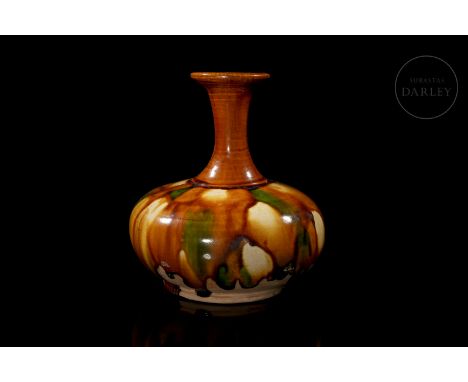 A modelled ceramic vase with a circular base and a flat body that narrows at the shoulders, where it has an elongated, flarin