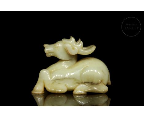 Jade carved in a single piece, light in colour with brownish flecks. It depicts the figure of a young stag, with its legs tuc