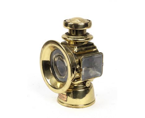 A Lucas model 526 oil illuminated sidelight,left-hand light, brass bodied with side flange mount, 4 inch diameter main lens i
