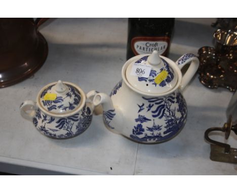 An "Old Willow" patterned teapot; together with an "Old Willow" patterned sugar bowl