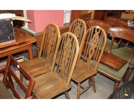 A set of four stick and wheel back dining chairs; together with a drop leaf table