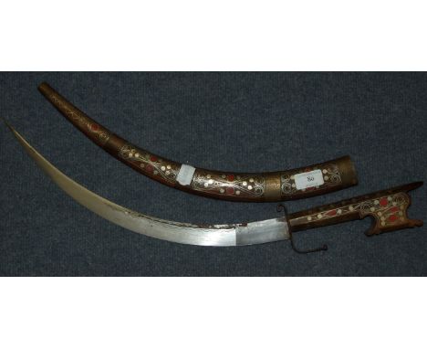 An Arabian Nimcha dagger with an inlaid handle and scabbard, 62 cm 