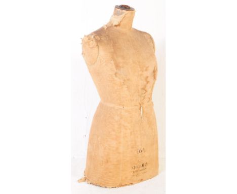 A mid 20th century circa 1940s dress shop mannequin torso. With a wooden frame and material cover. With makers label to front