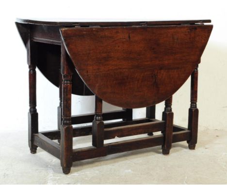 An 18th century oak drop leaf gate extending dining table. Of rectangular form with curved half circle drop leaves and gate l