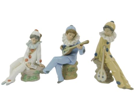 Three Nao figures, each modelled as a Pierrot, the largest 20cm high, each boxed.