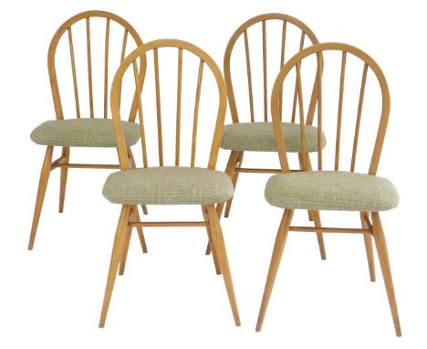 A set of four Ercol light elm dining chairs, each with a loop spindle back, solid seat with later stud work upholstery, on cy