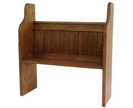 A late 19th/early 20thC pine pew, with a panelled back and shaped end supports, on a solid seat, 105cm high, 99cm wide, 34cm 