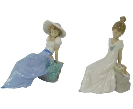 Two Nao porcelain figures, each modelled as a young lady seated on a bench beside a bird, 20cm high, both boxed. 