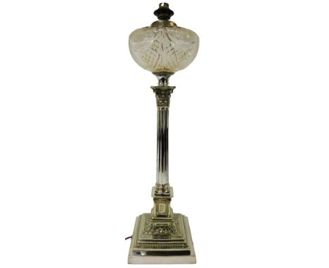 A late 19thC silver plated oil lamp, with a cut glass central reservoir, raised on a corinthian column, on a stepped square b