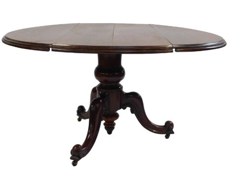 A Victorian walnut oval drop leaf table, the top with a moulded edge, on a turned column and scroll carved tripod base, 74cm 