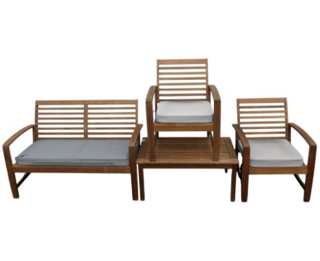 A teak garden set, comprising bench, 122cm wide, two armchairs, and a table. 