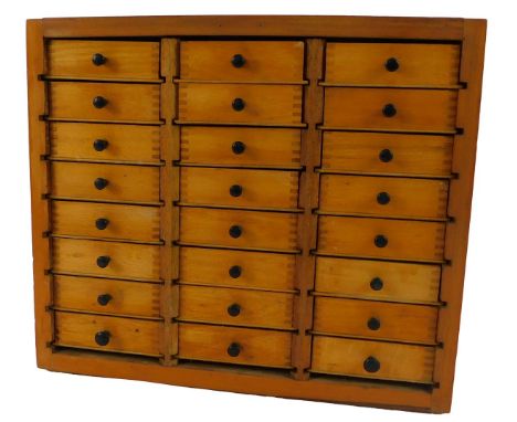 A 20thC teak watch maker's or specimen chest, of twenty four drawers, with ebonised knobs, 31cm high, 36cm wide, 22.5cm deep,