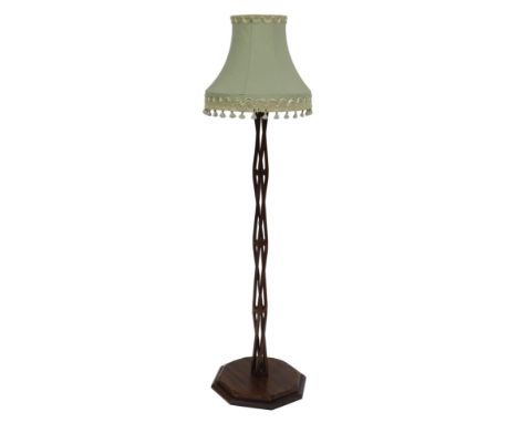 A 20thC mahogany standard lamp, the column of pierced twisted form, on an octagonal base, with shade, 152cm high. 