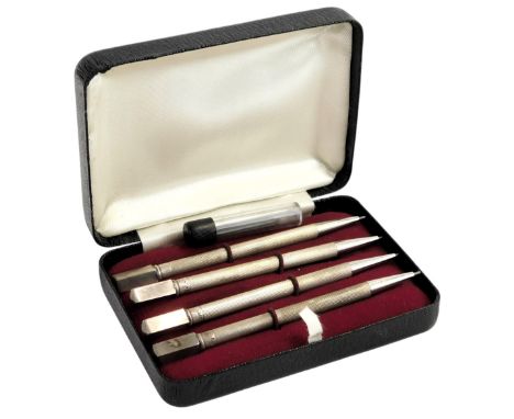 Four silver bridge pencils, with engine turned decoration, marked sterling silver, in a fitted case.