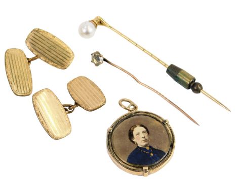 A Victorian circular memorial locket, set with a photograph of a lady, verso pearl tied hair, in a Prince of Wales feather de