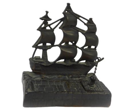 A 20thC cast iron inkstand depicting HMS Victory, the lidded inkwell connected via a chain to the ship, beside a recess, 16cm