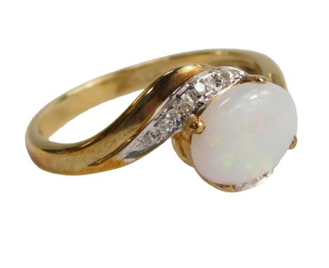 A QVC 9ct gold opal and diamond ring, the central opal claw set surrounded by five diamonds to each shoulder, size P, 2.5g al