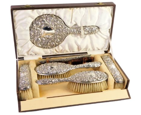 A Victorian silver backed dressing table set, comprising mirror, two clothes brushes, two hair brushes and a comb, (AF), each