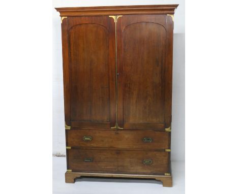 Campaign style mahogany gentleman's wardrobe, late 19th Century, cavetto moulded cornice over two recessed arched panel doors