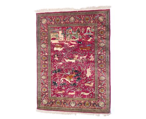 Fine pictorial hunting rug, late 20th Century after a Mughal original, the ruby red field dispersed with a myriad of fantasti