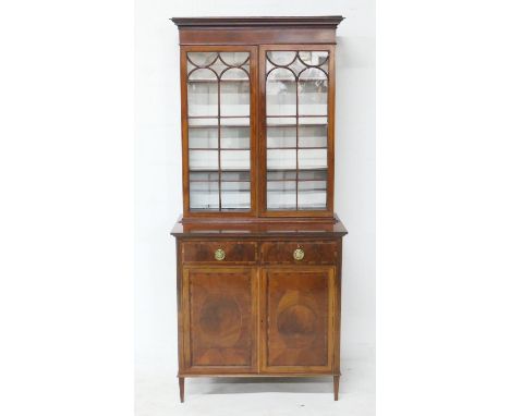 Edwardian mahogany and rosewood banded bookcase cabinet, retailed by H F Thomas, Eastgate Street, Chester, having a moulded c