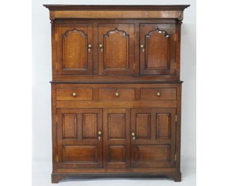 Oak joined deuddarn, North Wales, circa 1780, having a moulded cornice with a plain frieze and turned baluster drop finials, 