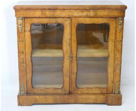 Victorian walnut and inlaid side cabinet, circa 1860, having an inlaid foliate frieze in satinwood and harewood, two shaped g