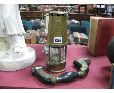 A Type Six Brass Miners Lamp, and an early XX Century cast brass and an early XX century cast brass and hardwood bruce stampe