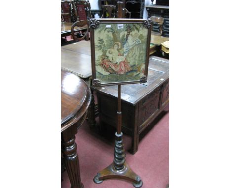 A XIX Century Mahogany and Rosewood Pole Screen, with turned finial, religious needlework panel on barley twist pedestal and 