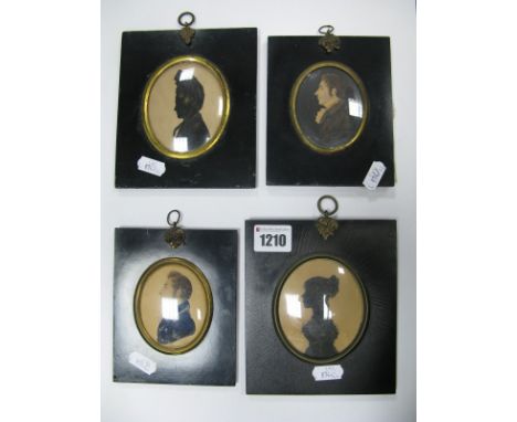 A XIX Century Silhouette of a Lady, wearing a large bonnet and black cloak, in a rectangular ebonised and black frame, 8 x 7c