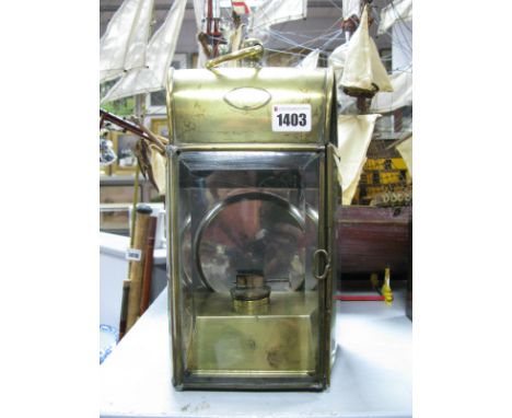 An Early 1900's Brass Ships Lamp, with original burner and bevelled glass to three sides 30cm high with loop handle down.