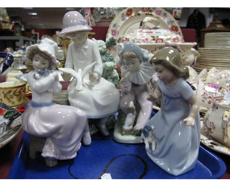 Nao Pottery Figure, of girl admiring dove A18-MY, 21cm high, three others with puppies. (4)