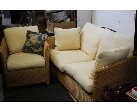 A wicker conservatory sofa and chair
