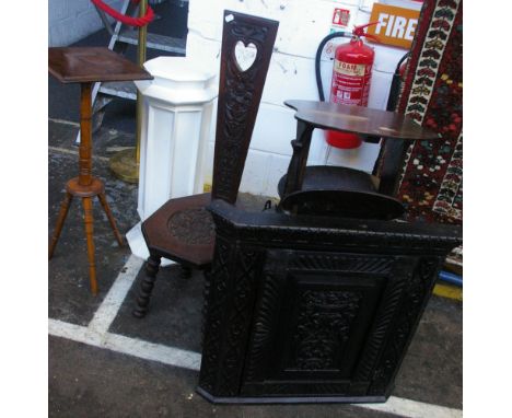 An early 20th Century oak sewing chair, with floral carved decoration and heart cut out motif to the back, a painted white pe