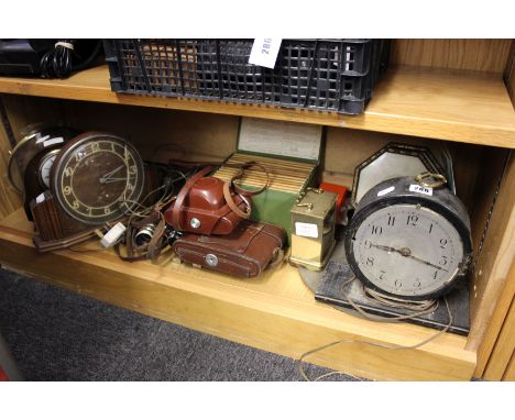 A 1930's oak mantel clock, two further mantel clocks, a carriage clock, group of vintage cameras and binoculars, brass sundia