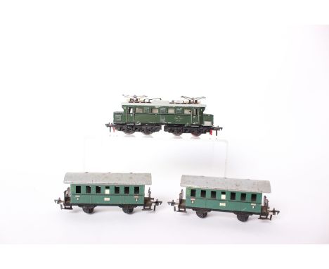 A Fleischmann HO 1345 electric locomotive in green(unboxed) together with two unboxed wagons. 