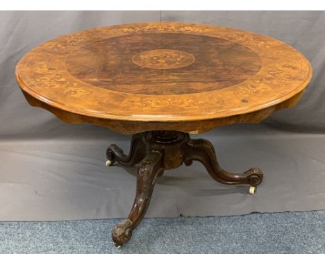 VICTORIAN INLAID BURR WALNUT CIRCULAR BREAKFAST TABLE on a turned column and tripod carved supports with castors, 74cms H, 13