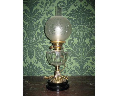 THIS LOT IS PART OF THE CONSIGNMENT FROM BODELWYDDAN CASTLE A CIRCULAR BLACK &amp; BRASS BASED ELECTRIFIED OIL LAMP with clea