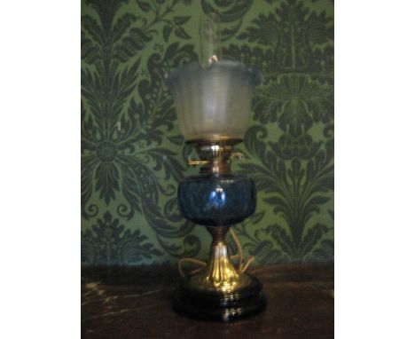 THIS LOT IS PART OF THE CONSIGNMENT FROM BODELWYDDAN CASTLE A BLACK &amp; BRASS BASED ELECTRIFIED OIL LAMP with blue reservoi