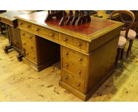 Late Victorian oak nine drawer pedestal desk, 136cm wide