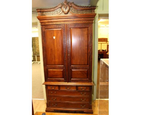 Mahogany Chinese Chippendale style press, the top having two panelled doors above a base of three short above three long draw