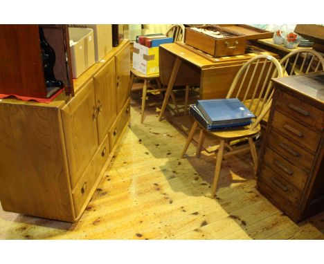 Ercol Windsor six piece dining suite comprising three door sideboard, drop leaf table and four spindle back chairs