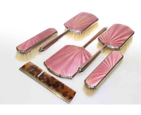 Silver and pink enamel dressing table set (5) and a silver -mounted comb (2)