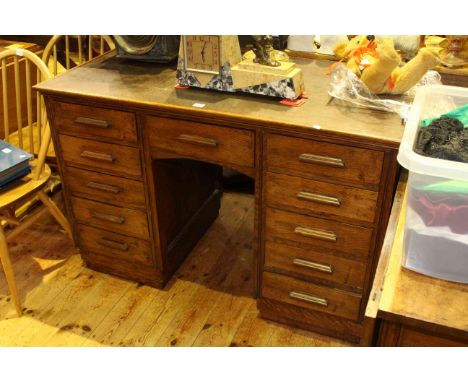 Early 20th Century oak eleven drawer pedestal desk, 117cm