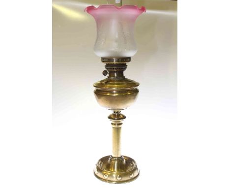 Brass column oil lamp with ruby tinted etched glass shade