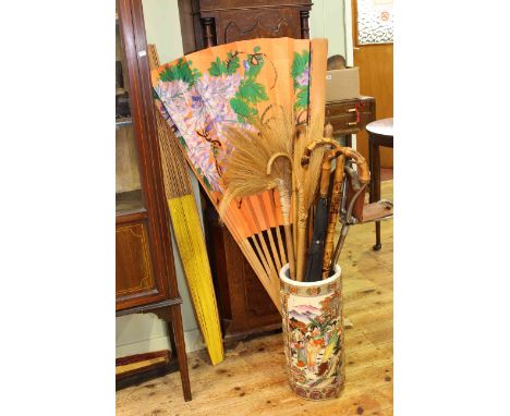 Oriental pottery stick stand, walking sticks, brolly, shooting sticks and large painted fans