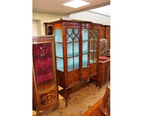 Edwardian mahogany and string inlaid bow front centre vitrine on square tapering legs joined by a shelf, 128cm by 182cm